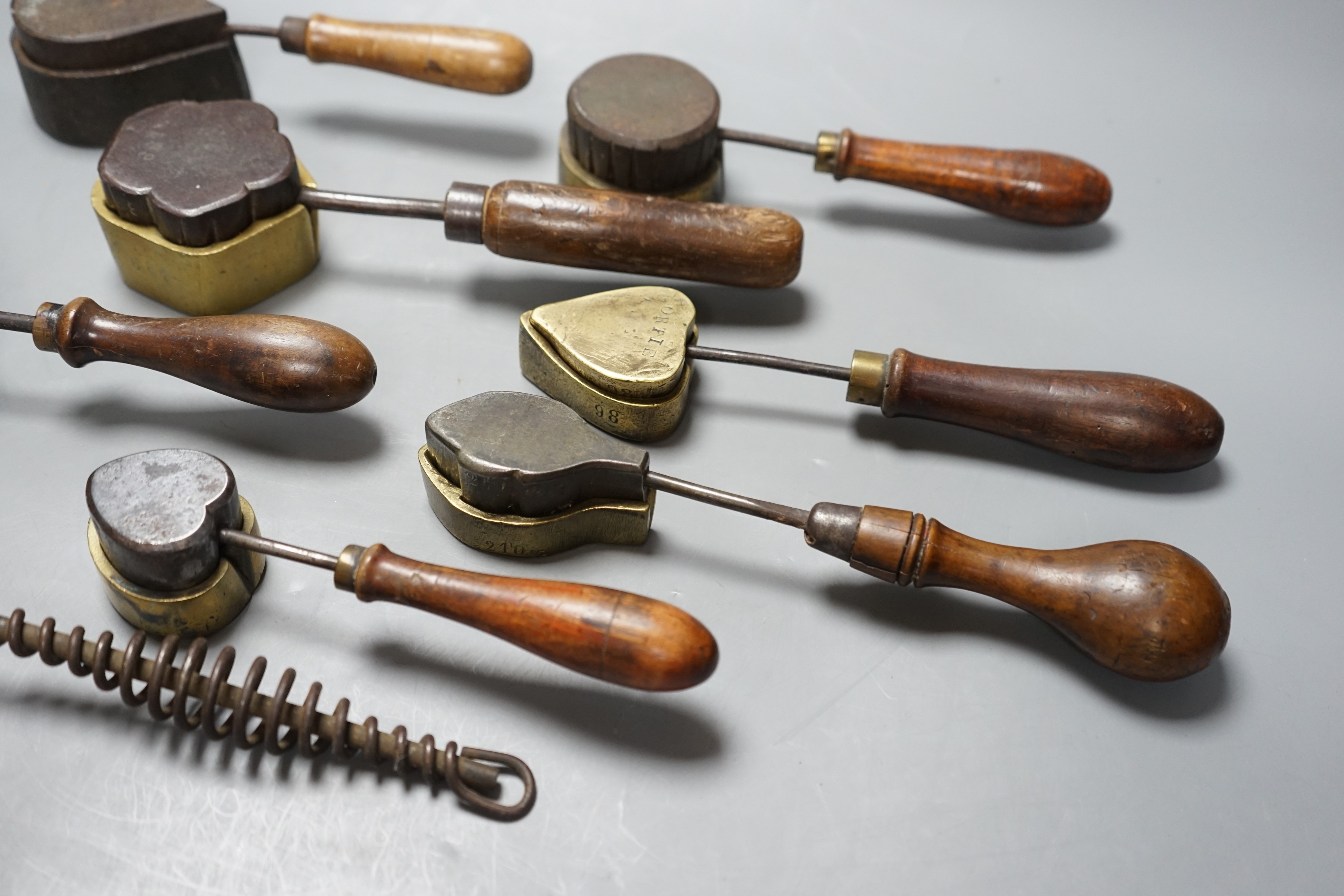 A collection of eight 19th century cast metal moulds for possibly hand embossing silk